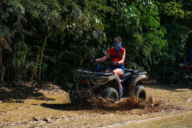 Four Wheel ATV Ride in Punta Cana - Macao Beach stop: sand, limestone cliffs, and souvenir browsing
