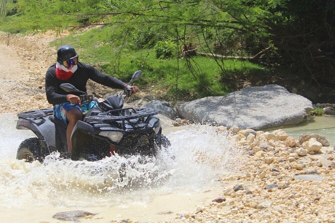 Shore Excursion: Combo Atv & militare waterfalls | No long lines - ATV riding through sugar cane fields and river edges